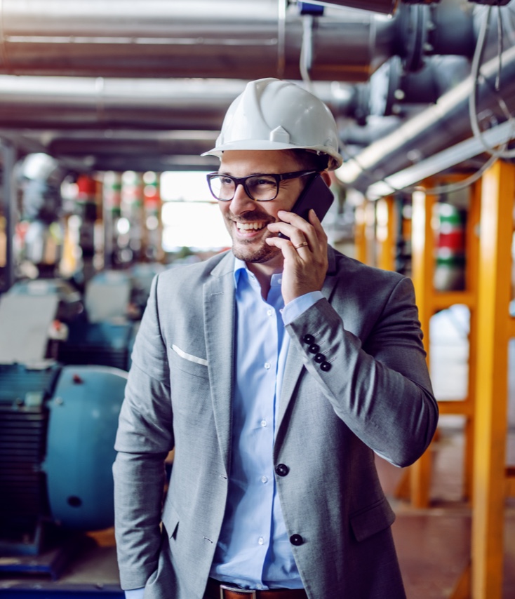 Man in hard hat talking on phone