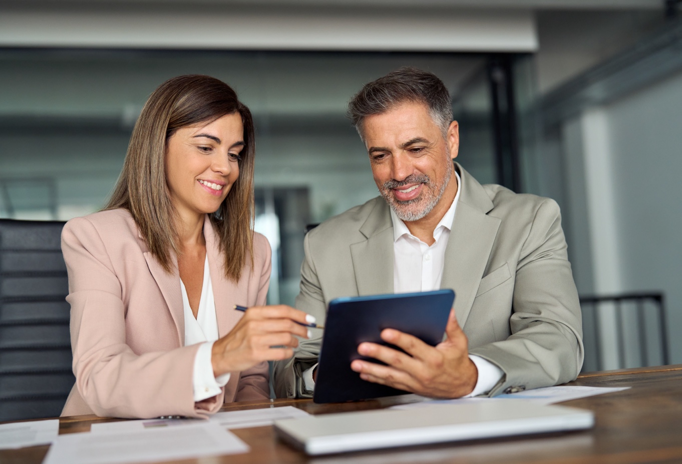 two professionals looking at report